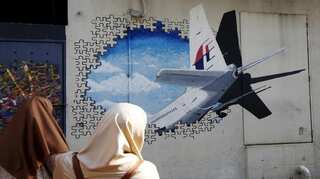 Indian Ocean search for missing Malaysia MH370 aircraft slows due to bad weather