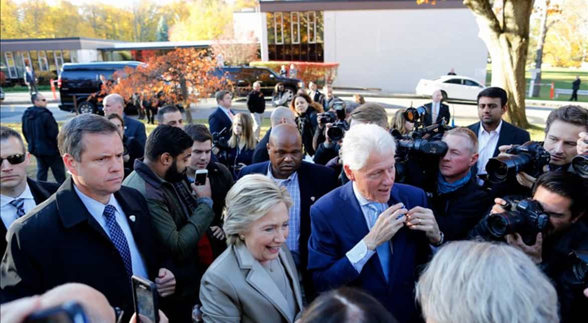 A beaming Hillary and Bill Clinton greet supporters after casting their vote.