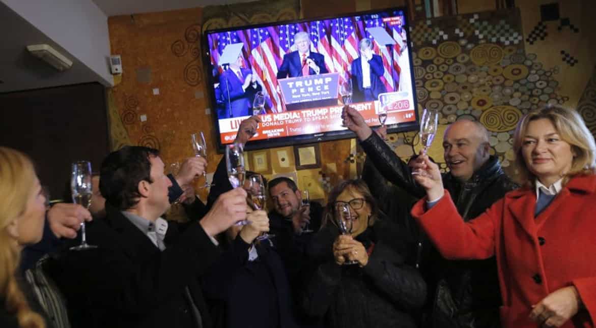 Residents of Sevnica, hometown of Melania Trump, raise a toast as the news of Trump's victory is flashed.