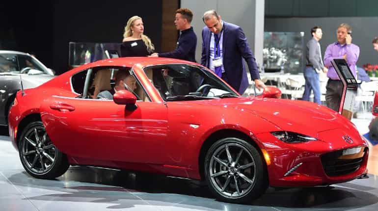 People check out the new Mazda MX-5 at the auto show.
