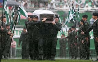 In pouring rain, Brazil town mourns fallen football team