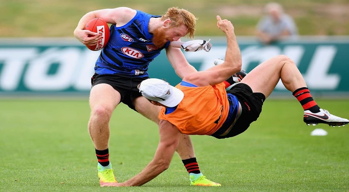 Aaron Francis of the Bombers is tackled by Cale Hooker during an Essendon Bombers AFL pre-season
