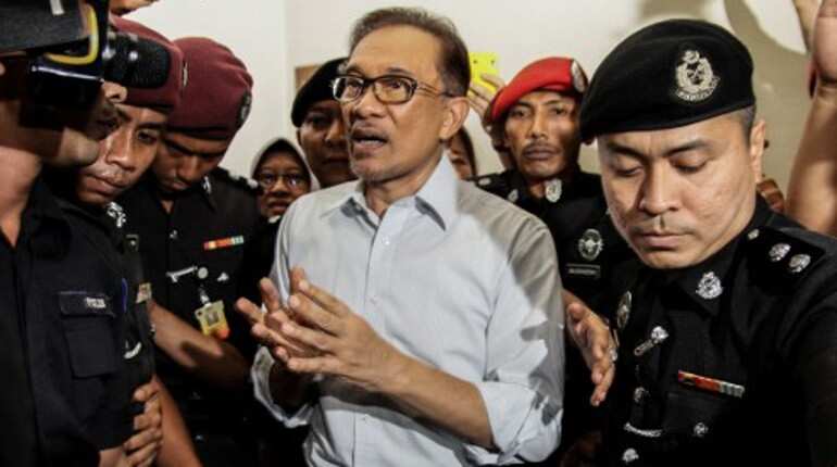 Jailed Malaysian leader Anwar urges voters to pick former nemesis Mahathir
