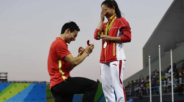 Silver medallist China's He Zi receives a marriage proposal from Chinese diver Qin Kai during a podium ceremony.