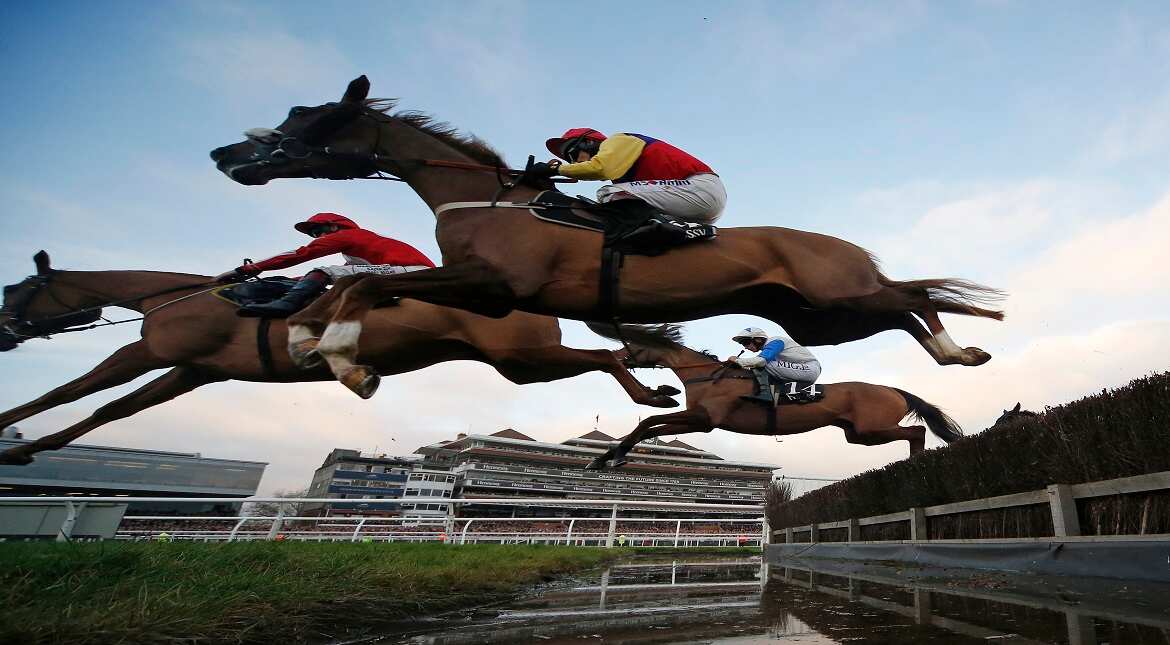 Richard Johnson riding Native River clear the water jump before winning