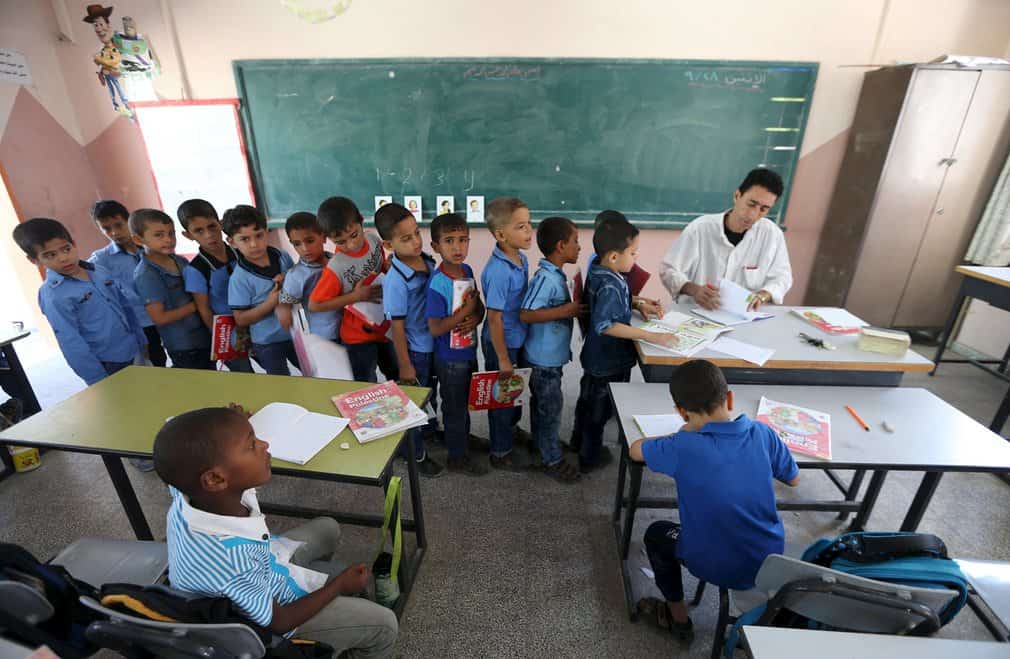 Rafah, Gaza StripMohammed Zurob marks a book for his first grade students during an English lesson at Taha Huseen elementary schoolPhotograph: Ibra