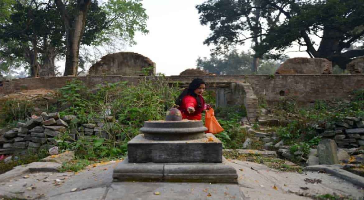 A Nepalese Hindu devotee offers various plant seeds during the Bala chaturdashi festival at the Pashupatinath temple