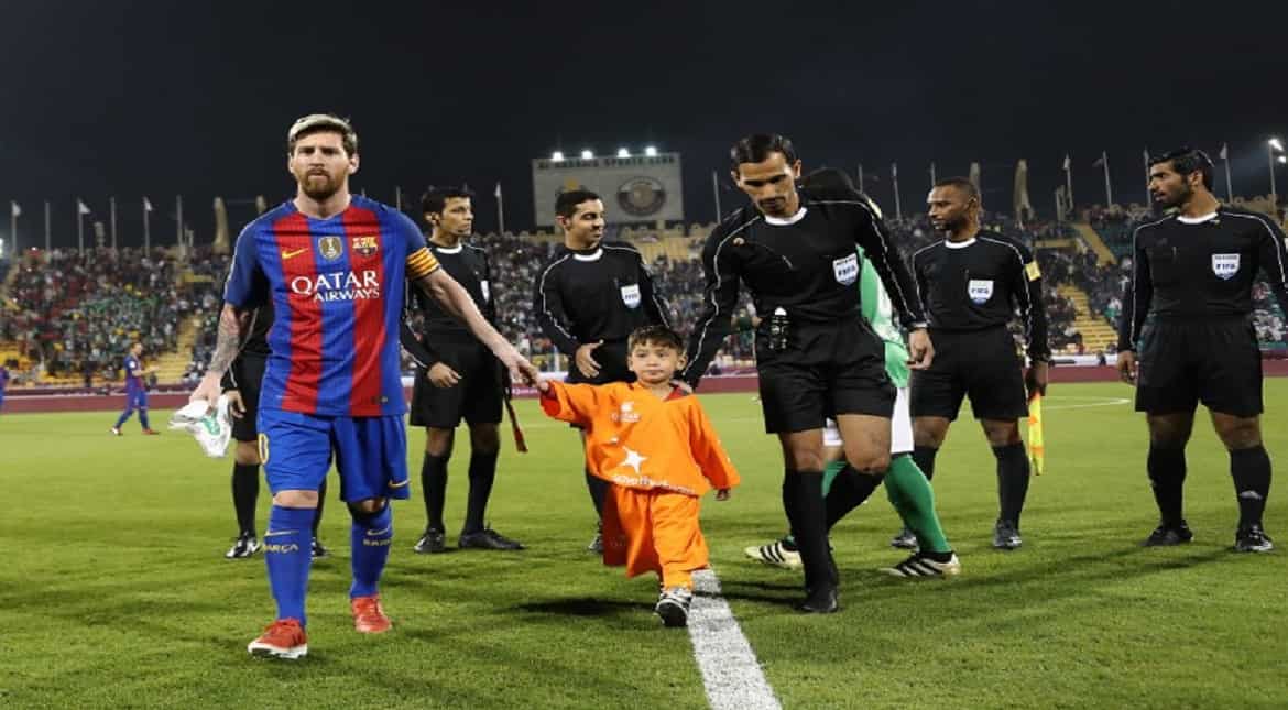 FC Barcelona Lionel Messi holds the hands of Afghan boy Murtaza Ahmadi