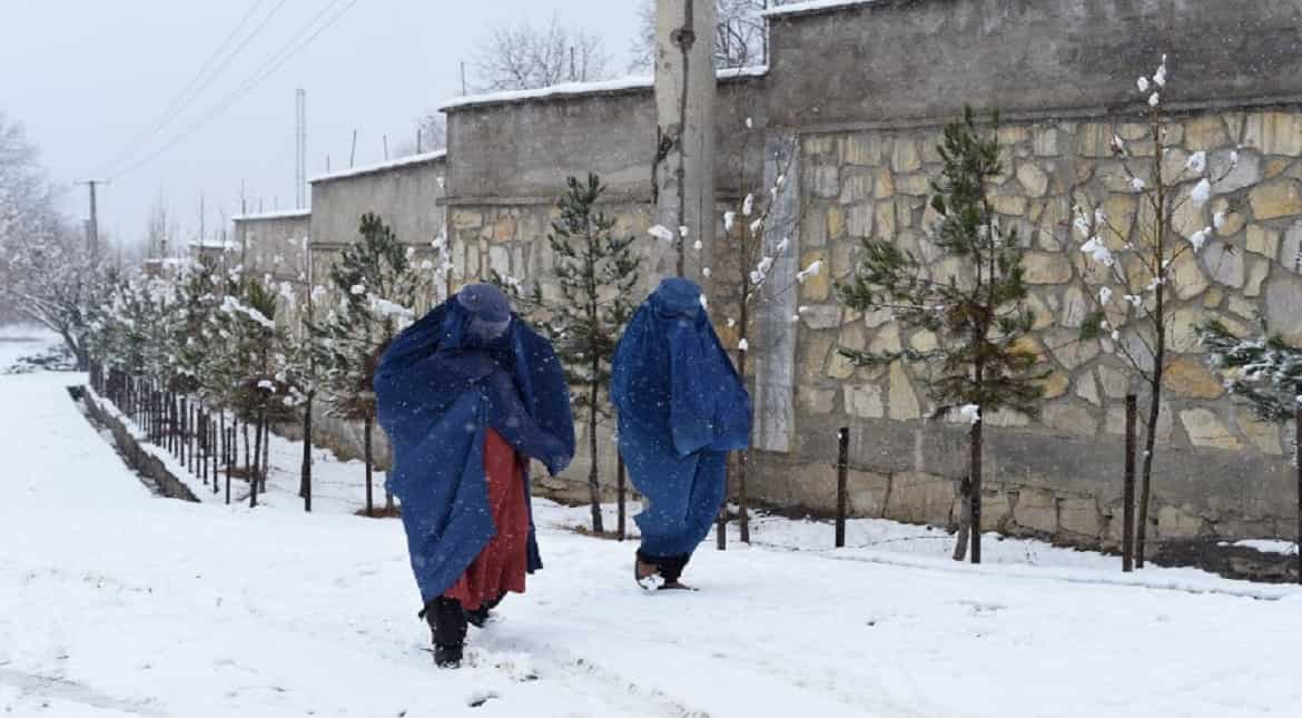 Afghan women walk through a snowfall in Paghman district some 21kms west of Kabul.