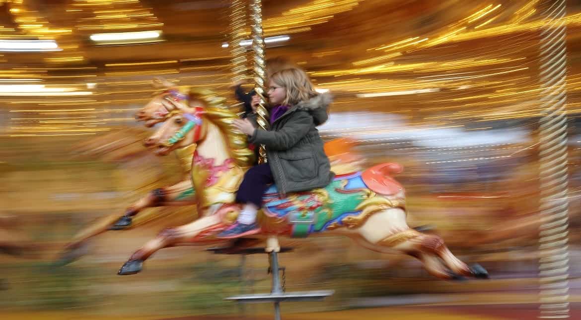 A young girl enjoys a Merry-Go-Round outside the Natural History Museum in London, England.