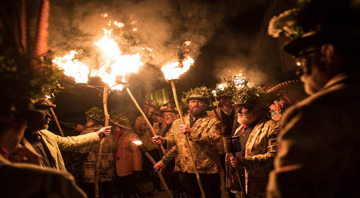 Members of the Leominster Morris lead the crowd from the Hobson Brewery in Frith Common to the nearby apple orchard