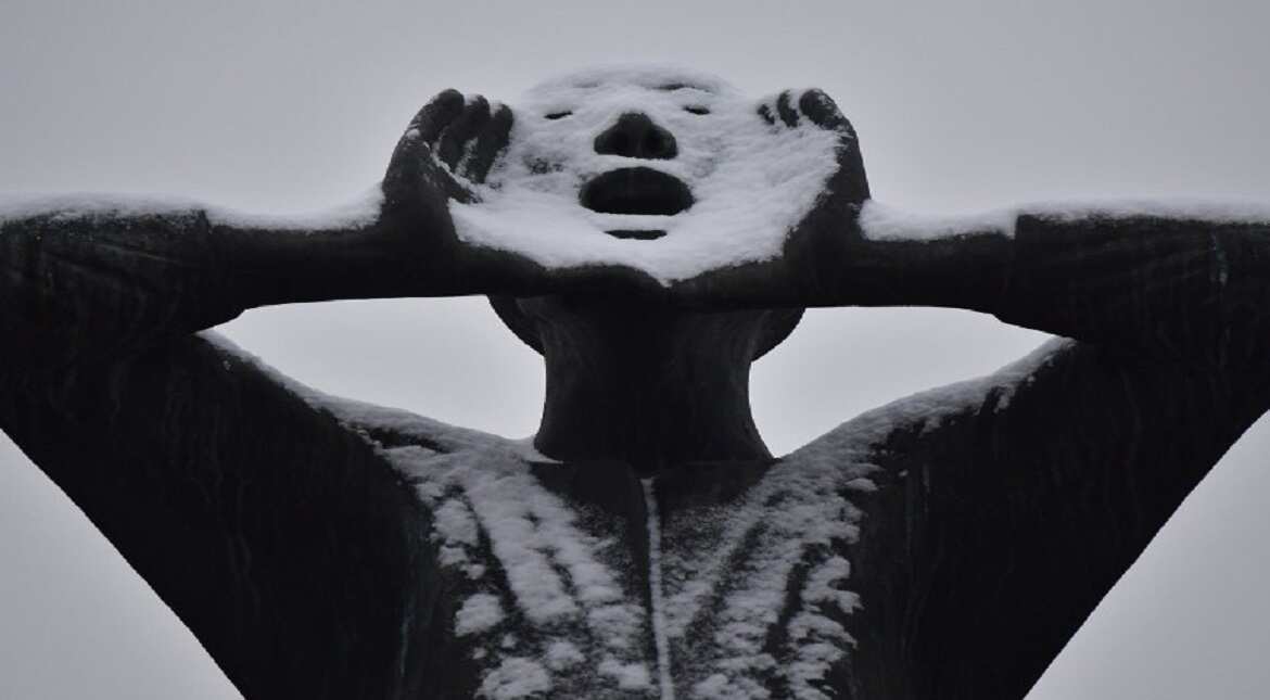 Snow coats a statue in front of the Brandenburg Gate in Berlin.
