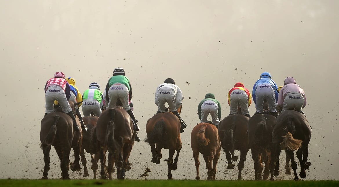 Runners make their way into the fog at Chepstow Racecourse in Chepstow, Wales.