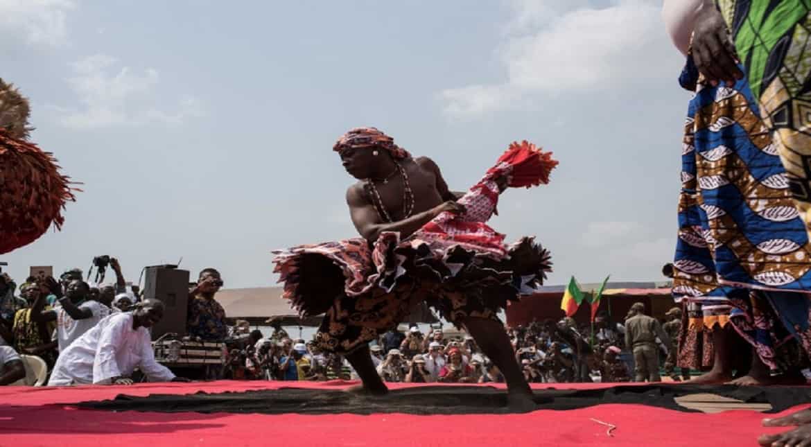 A Vodoo devotee dressed up in a costume performs at the annual Voodoo Festival in Ouidah.