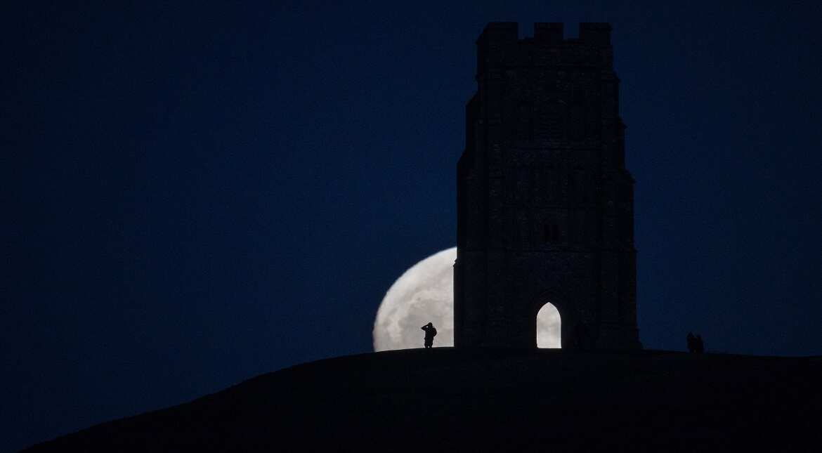 A so-called wolf moon rises over Glastonbury Tor  in Somerset, England. In some parts of the world, the January full moon is nicknamed the wolf moon.