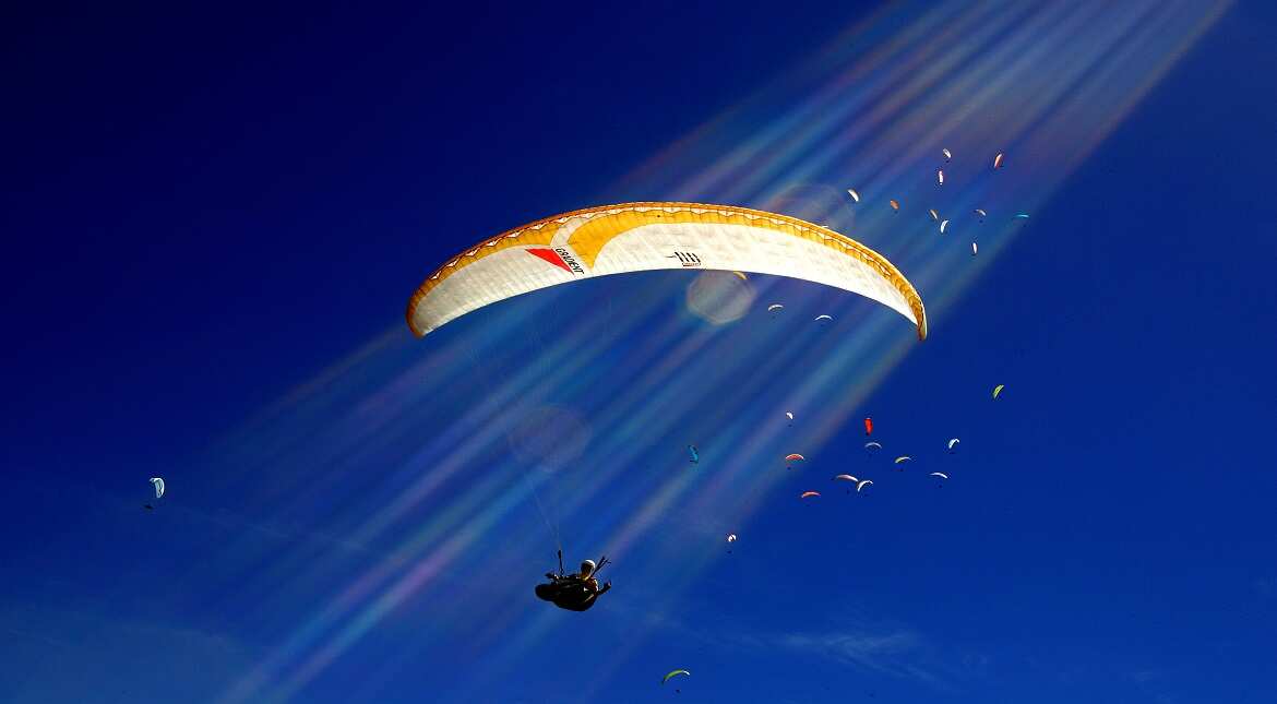 A competitor glides through the sky during the 10th FAI Paragliding World Championships in Manila, Australia.