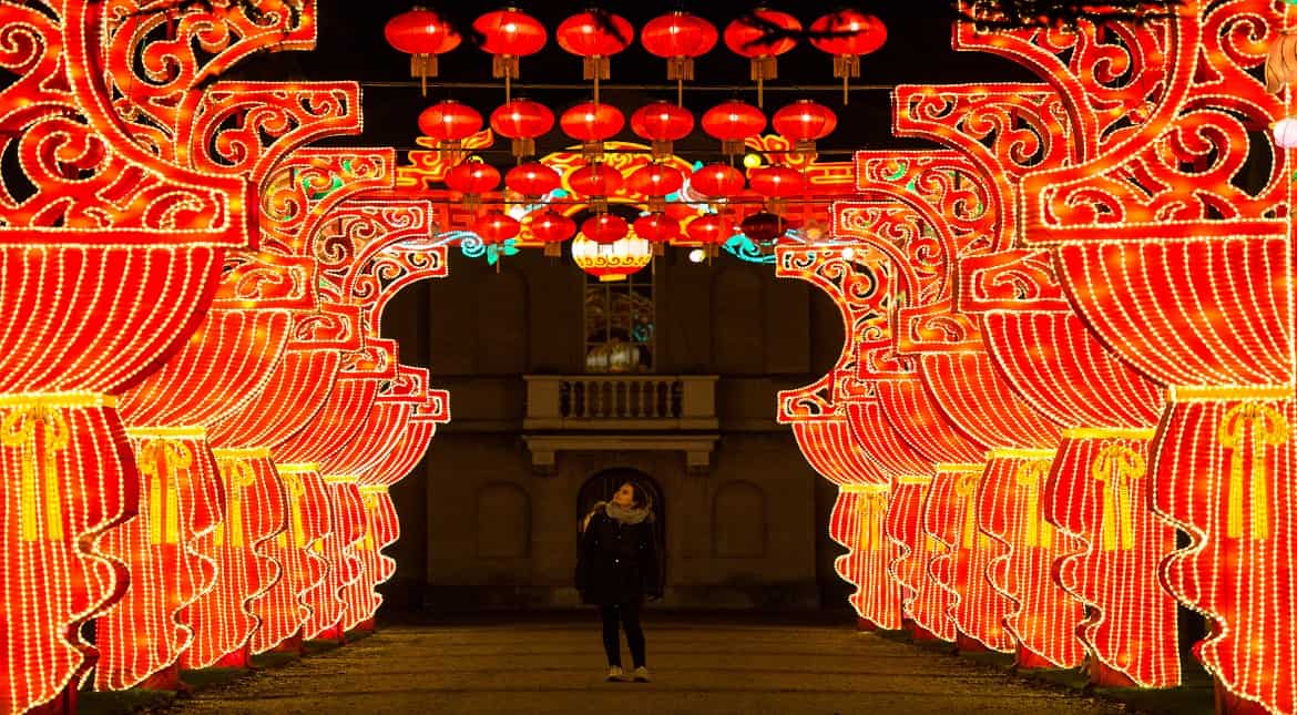 A woman walks through a canopy of lanterns and lit borders during a preview of the Magical Lantern Festival at Chiswick House and Gardens in London, England.