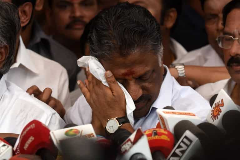 Acting chief minister O Panneerselvam of the southern Indian state of Tamil Nadu reacts after India's top court convicted his rival Sasikala.