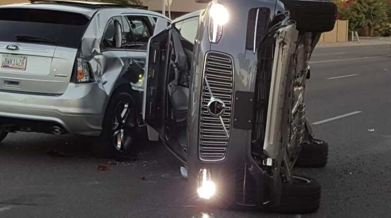 Uber suspends self-driving car program after crash, vehicle flips on side