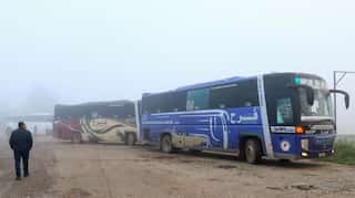 Buses evacuate hundreds from four besieged Syria towns under evacuation deal