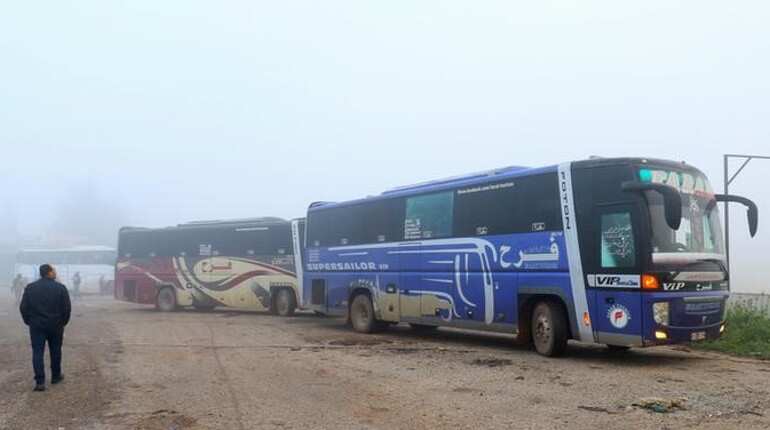 Buses evacuate hundreds from four besieged Syria towns under evacuation deal