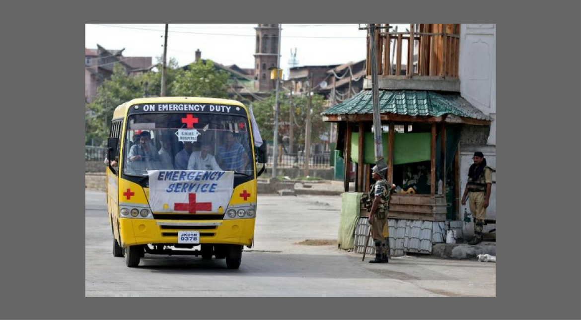 An emergency vehicle passes a security checkpoint in Srinagar after an escalation of violence on August 17, 2016