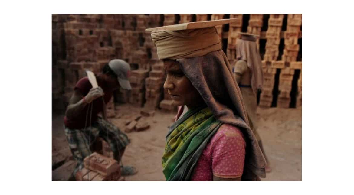 An Indian labourer works at a brick factory near Allahabad on April 30, 2017, on the eve of International Labour Day.