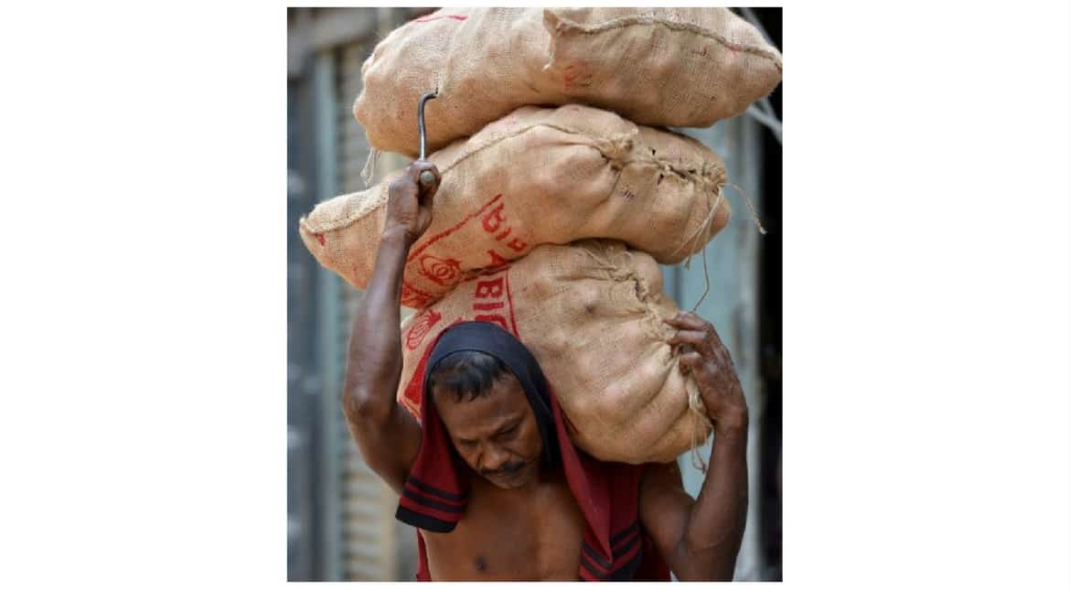 A Sri Lankan porter carries goods at the main market in Colombo on April 30, 2017, on the eve of International Labour Day or May Day.