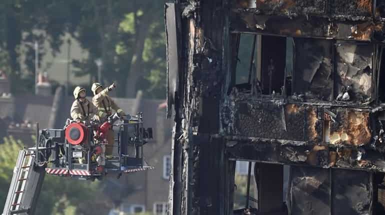 Theresa May rushed from area of London fire after protests
