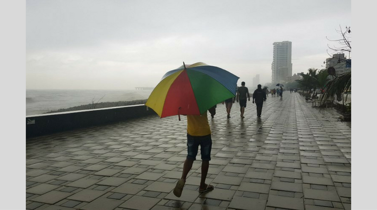 People going for long walks in Mumbai enjoying the sprinkling rain.