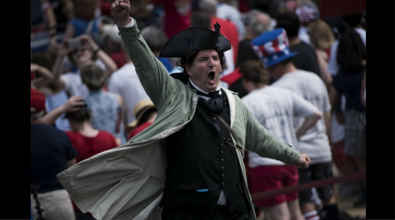 Man dressed in a costume cheering outside the National Archives show