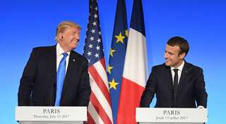 Isolated Donald Trump descends on G-7, talking trade war