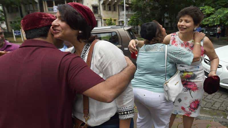 Indian Parsis exchange greetings outside a Fire Temple during Navroze, the Parsi New Year, in Mumbai on August 17, 2017.
