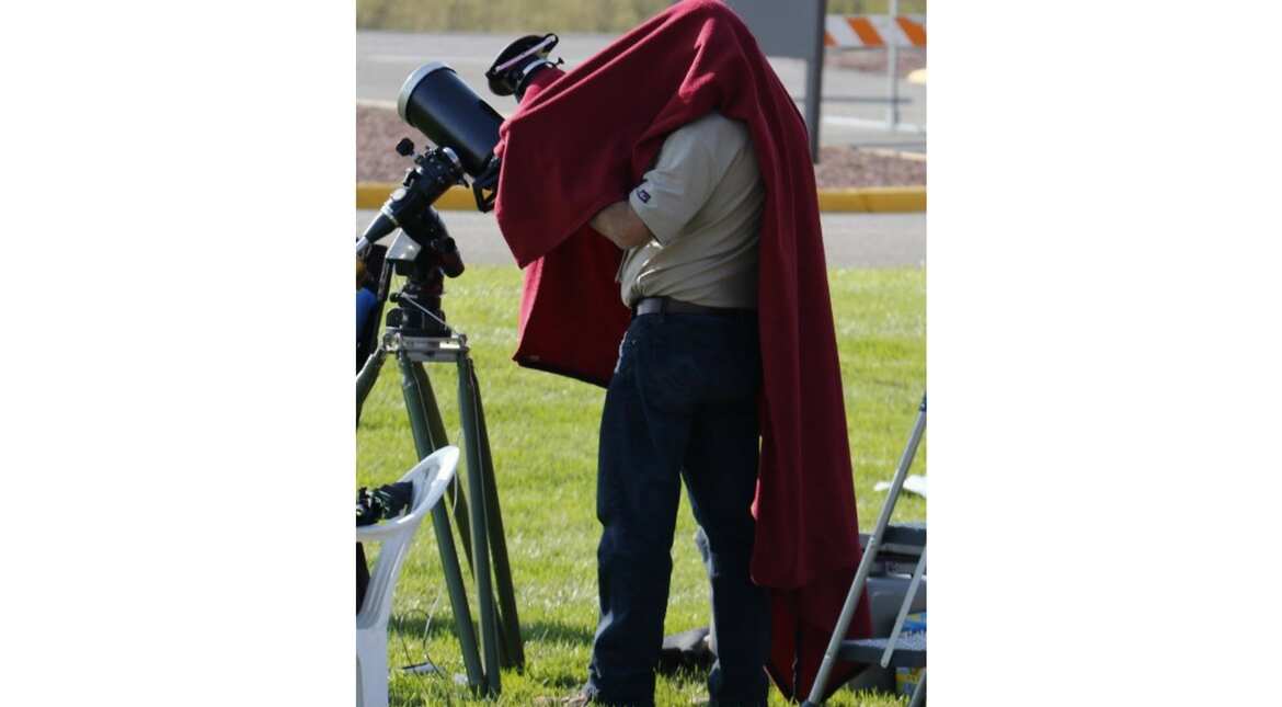 Astrocon attendees cover their cameras to capture the total solar eclipse