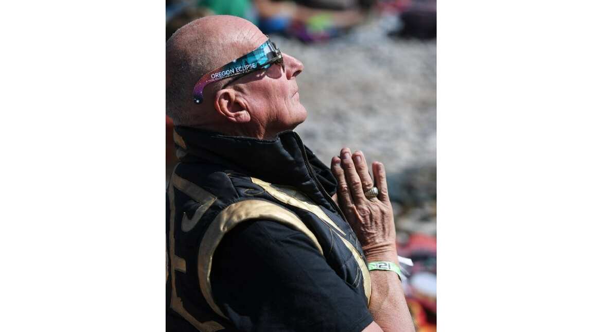 A man can be seen in a praying position at the site of solar eclipse in Oregon