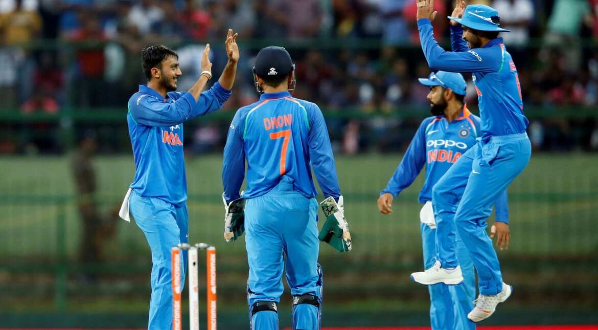 India's Axar Patel celebrates with his teammates after taking the wicket of Sri Lanka's Angelo Mathews