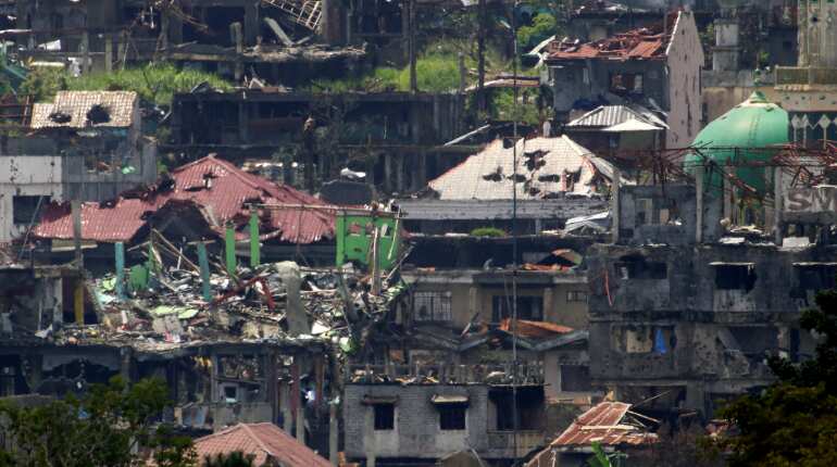 Philippine army says taking fire from women, children in Marawi battle