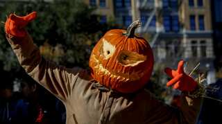 Exuberant and defiant, New Yorkers flock to Halloween parade despite attack