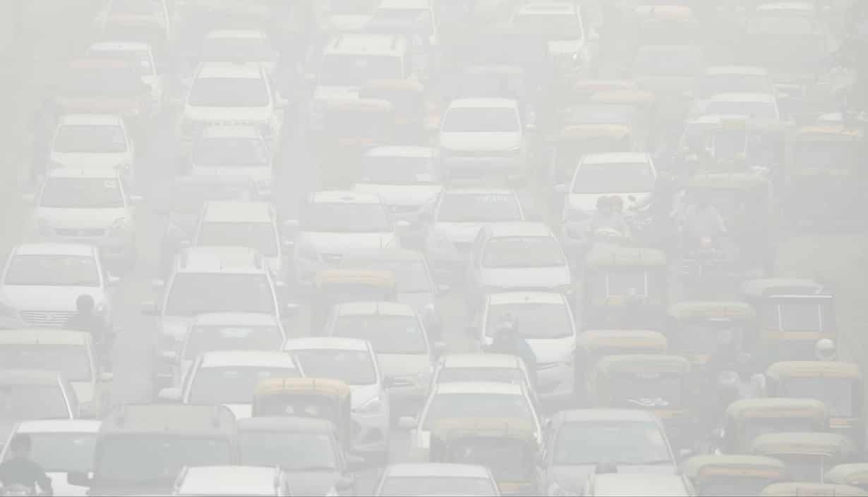 Vehicles drive through heavy smog