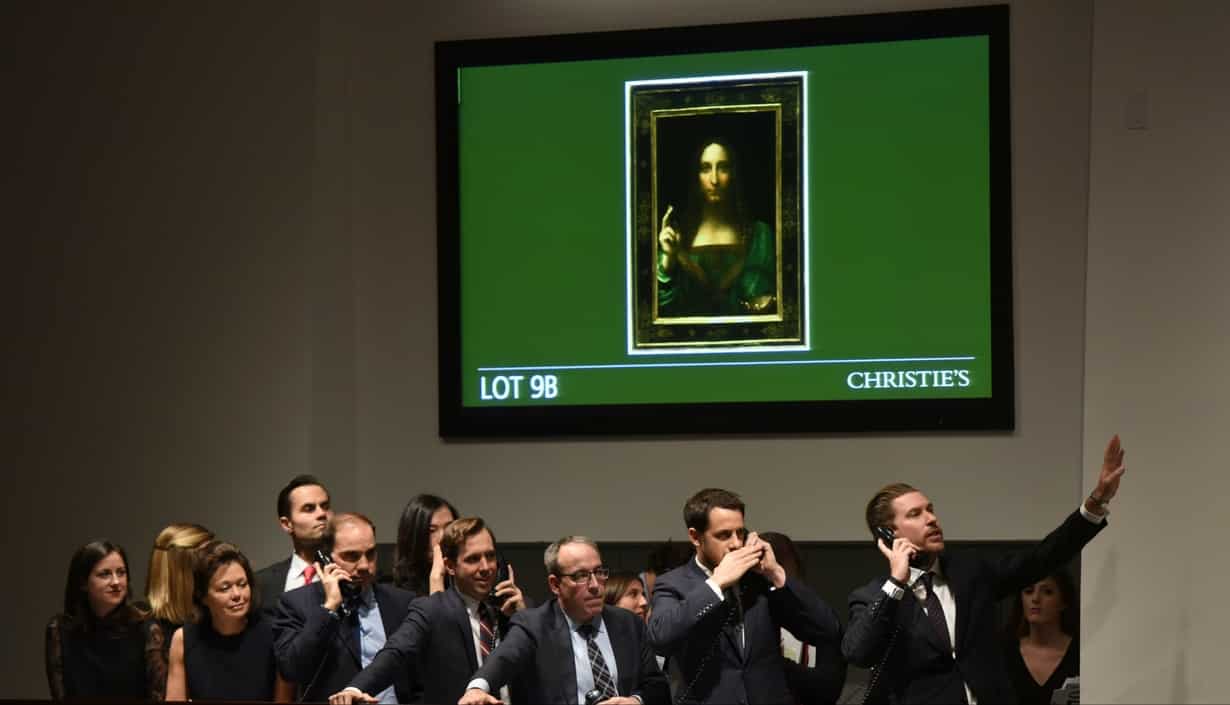 Christie's employees take bids for Leonardo da Vinci?s "Salvator Mundi"