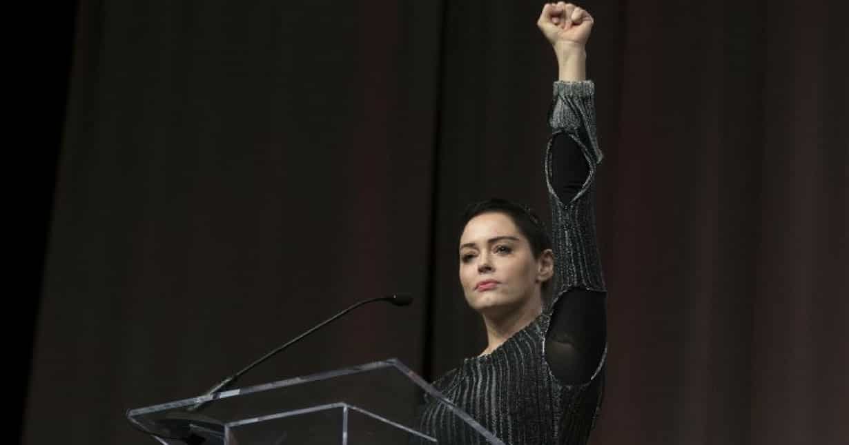 Rose McGowan raises her fist during her opening remarks to the audience at the Women's March