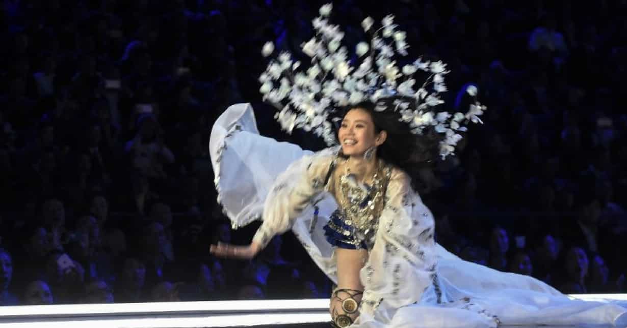 Chinese model Ming Xi falls as she walks during the Victoria's Secret Fashion Show 2017