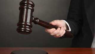 Comedian in court for blowing nose on national flag