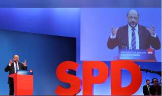 Germany's SPD votes for coalition talks with Angela Merkel