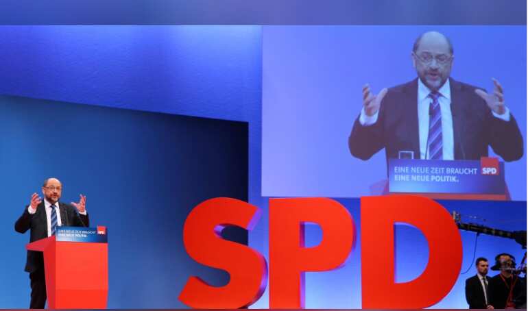 Germany's SPD votes for coalition talks with Angela Merkel