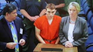 Head bowed, Florida shooting suspect returns to court for hearing