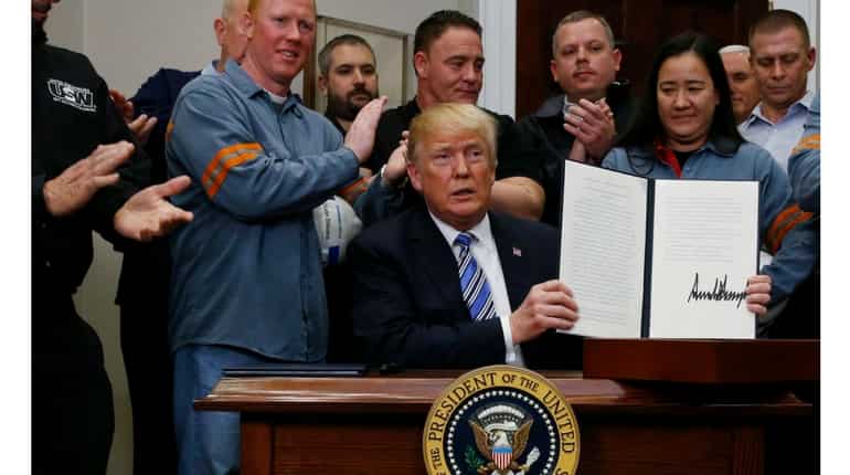Trump signs sweeping tariffs; Canada, Mexico exempted
