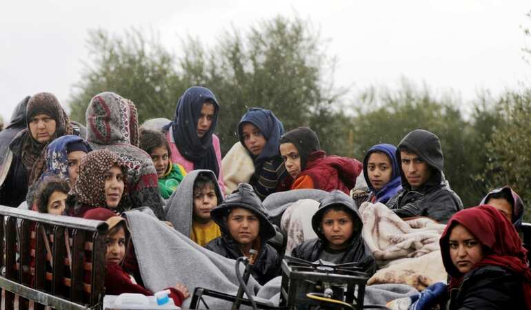 As Turkey attacks, hundreds of families flee Syrian town of Afrin