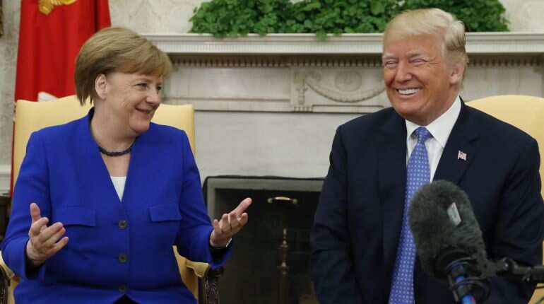 NATO summit: Trump changes tone in Merkel meeting after earlier slamming Germany