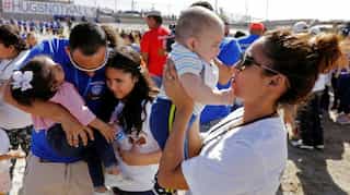 Families split for years hug for 3 minutes at US-Mexico border